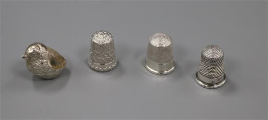 An Edwardian silver chick pin cushion and three silver thimbles including Charles Horner